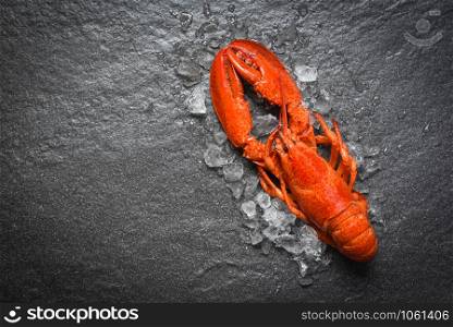 Red lobster seafood with ice on dark backgroud top view