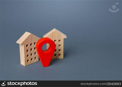 Red location pin and houses. Location concept, settlement. Tracking, internet of things. City navigation, orienteering. Search for housing options. Infrastructure and surroundings. Local searching.