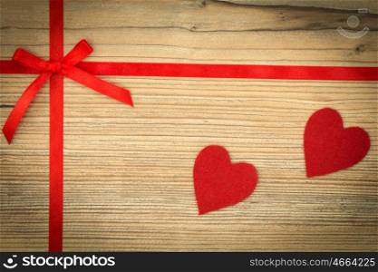 Red loop with hearts on wooden background