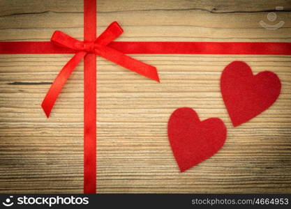 Red loop with hearts on wooden background