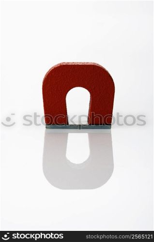Red magnet on white background.