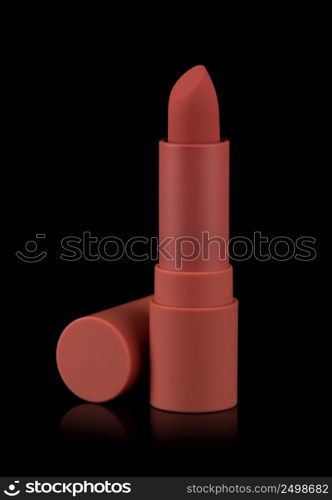 Red matt lipstick isolated on black background. Velvet satin airy lip stick new blank open with cap.
