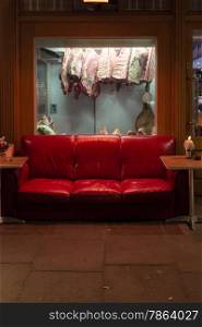 Red Meet (2). Red Sofa in front of butchers window