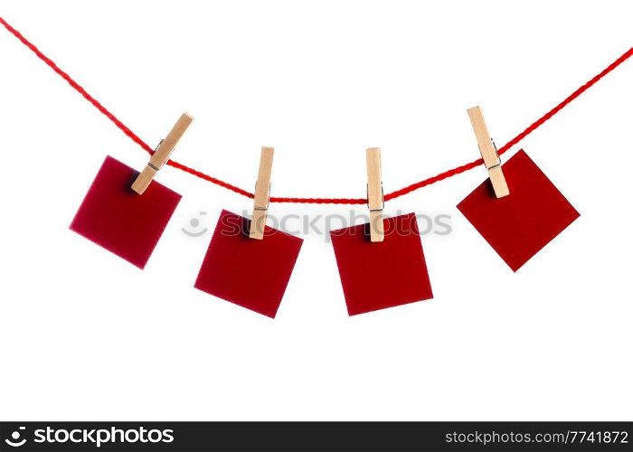 Red Memo papers with clothespins on a leash. Isolated on white background. Love copy space for letters. Memos with clothespins
