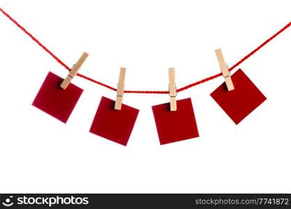 Red Memo papers with clothespins on a leash. Isolated on white background. Love copy space for letters. Memos with clothespins