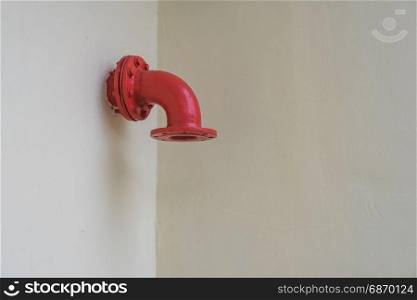 Red metal vent round industrial pipe on the white wall