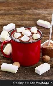 red metalic mug with hot chocolate and marshmallows