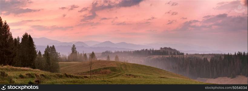 Red mountain morning panorama. Colorful dawn. High mountain landscape in haze