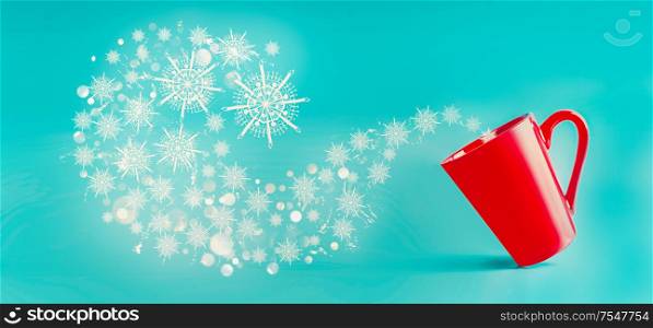 Red mug with flying snowflakes at blue background. Winter and Christmas concept. Creative layout with copy space for design