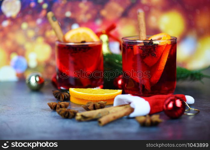 red mulled wine glasses decorated table / Christmas mulled wine delicious holiday like parties with orange cinnamon star anise spices for traditional christmas drinks winter holidays