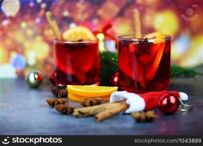 red mulled wine glasses decorated table / Christmas mulled wine delicious holiday like parties with orange cinnamon star anise spices for traditional christmas drinks winter holidays