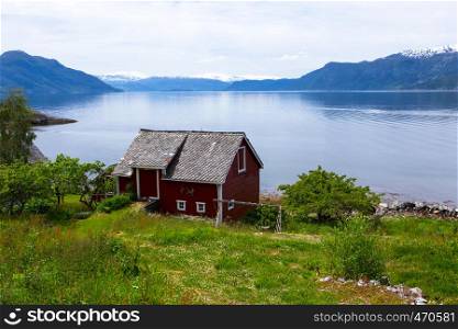 red norwegian rural house on a fjord coast