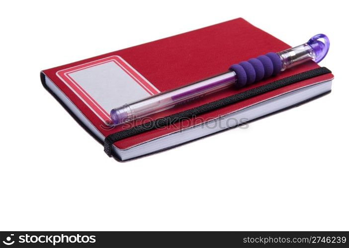 red notebook diary or agenda and purple pen lying on the top (isolated on white background)