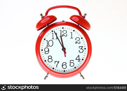 red old style alarm clock isolated on white