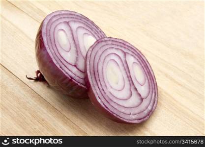 Red onion isolated on wood background