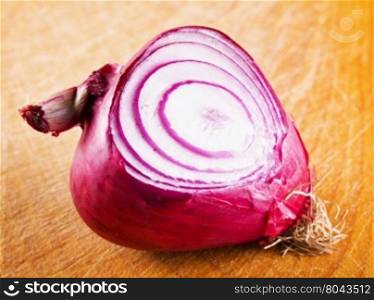 Red onion over chopping board, horizontal image