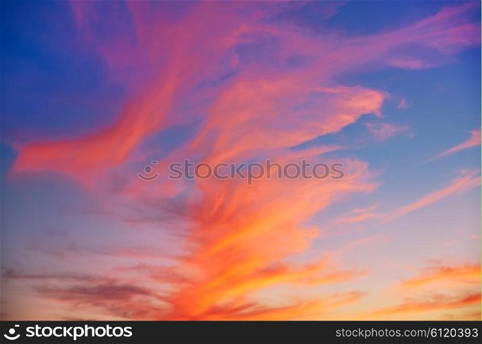Red orange clouds at sunset over blue sky