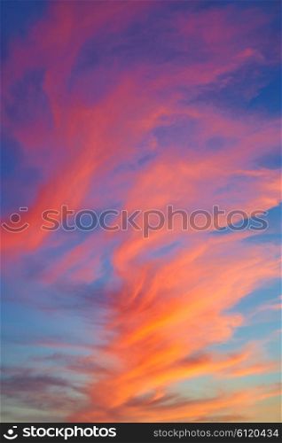 Red orange clouds at sunset over blue sky