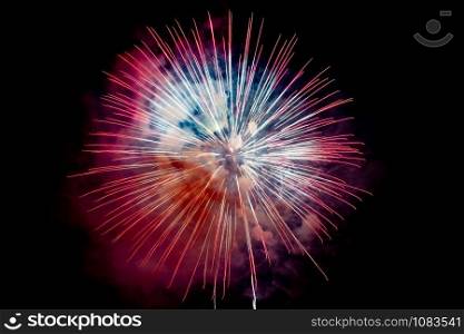 Red Orange Sparkling Fireworks Background on Night Scene. Abstract color fireworks background and smoke on sky