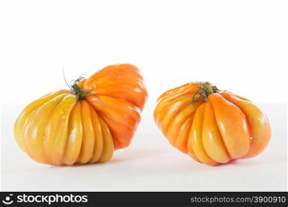 Red ox heart tomatoes on a white background