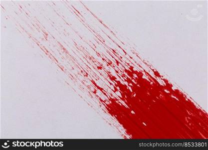Red paint splash on a white paper