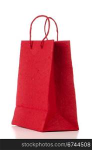 Red paper bag over white background.