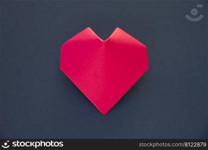 Red paper heart origami isolated on a blank grey background. Valentines day card. Red paper heart origami isolated on a grey background