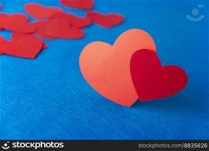 Red paper heart shape on blue textured background with copy space. Love Concept image. Valentine&rsquo;s day, mother&rsquo;s day, birthday greeting cards, invitation