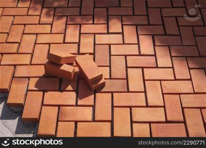 Red paving bricks on zig zag pattern of pedestrian sidewalk in under construction