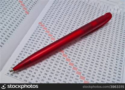 red pen on diary on white background