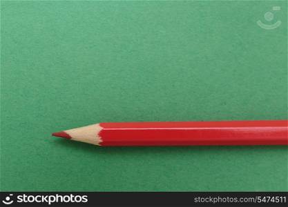 red pencil on a green background