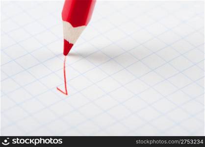 Red pencil writing a mark. Abstract concept