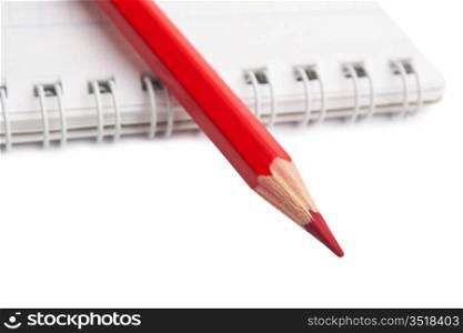 red pencils and notebook isolated on a white background