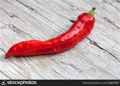 red  pepper on wood background
