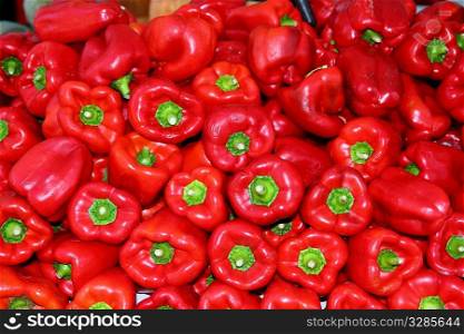 Red pepper stacked in market as pattern background vegetables