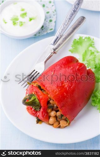 Red pepper stuffed with white beans on plate, close up, selective focus