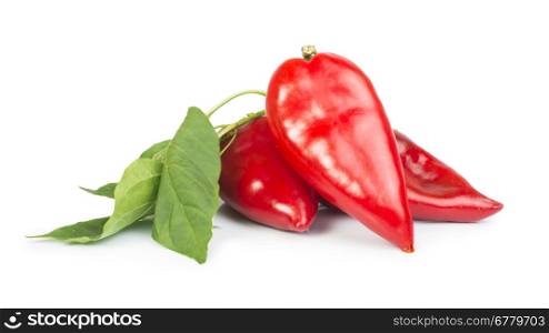 Red peppers and leaves.White isolated studio shot