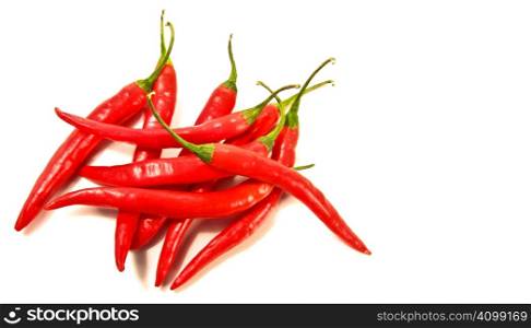 Red peppers laying against a white background