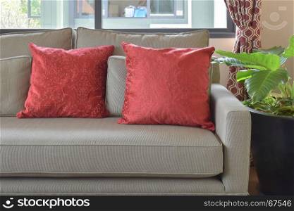 red pillows on brown sofa in living area at home