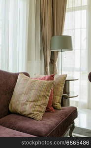 red pillows on red sofa in luxury living room interior