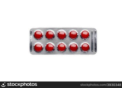 Red pills in blister pack isolated on white background. Red pills in blister pack isolated on white background.Top view