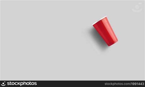 Red plastic cup isolated on grey. Beer pong game concept
