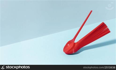 red plastic spoons copy space