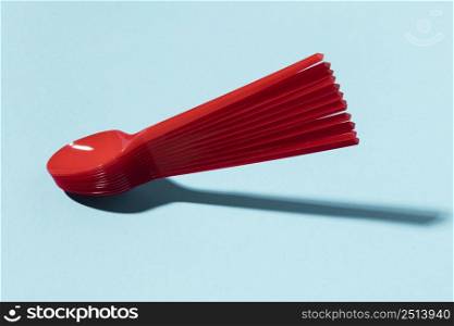red plastic spoons pile