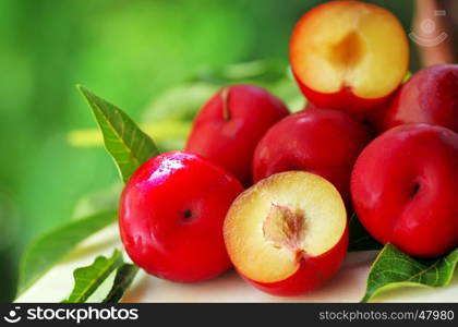 red plums on green background