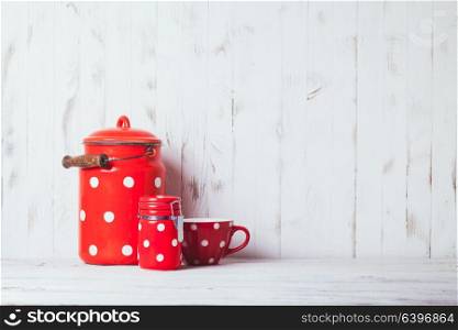 Red polka dot vintage kitchen utensils on a white talbe. Red polka dot utensils
