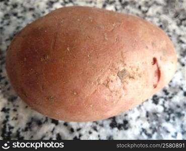 red potato with dirt as a background