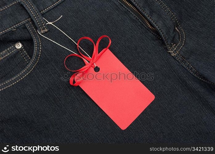 Red price tag over jeans