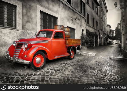 Red retro car on the street of Trastevere in Rome, Italy. Red retro car