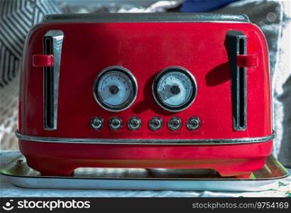 Red retro styled toaster for breakfast. Toaster in vintage style, Electric stainless steel toaster, Selective focus.